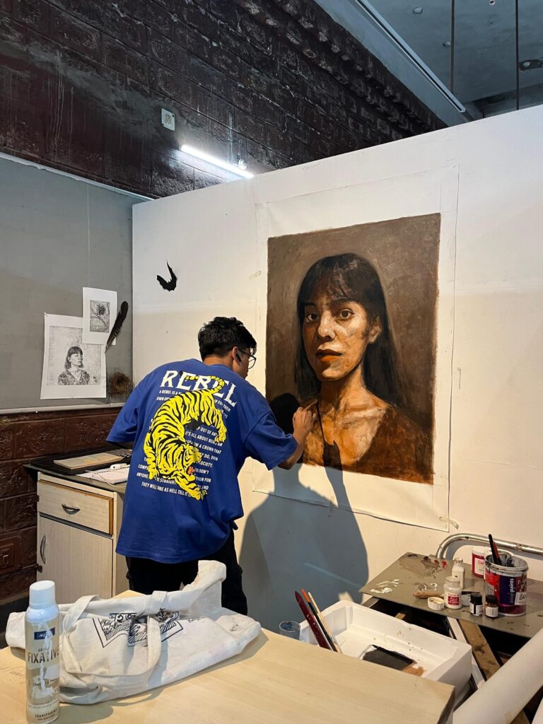 A student at an etching press